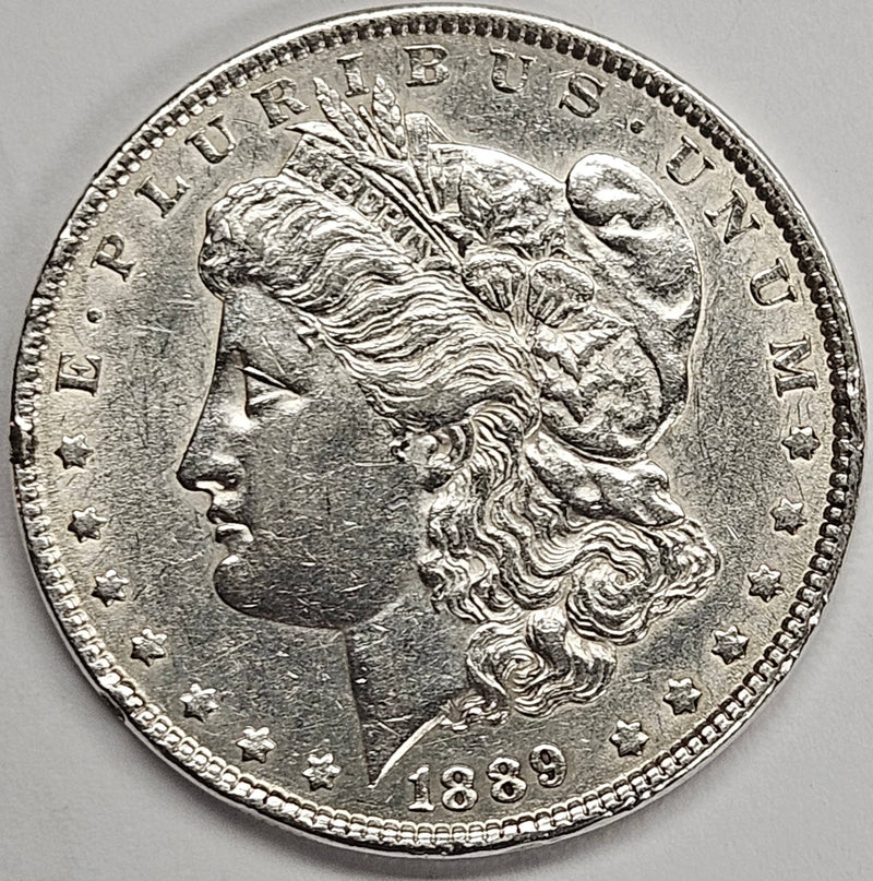 1889 Morgan Dollar . . . . AU rim bumps