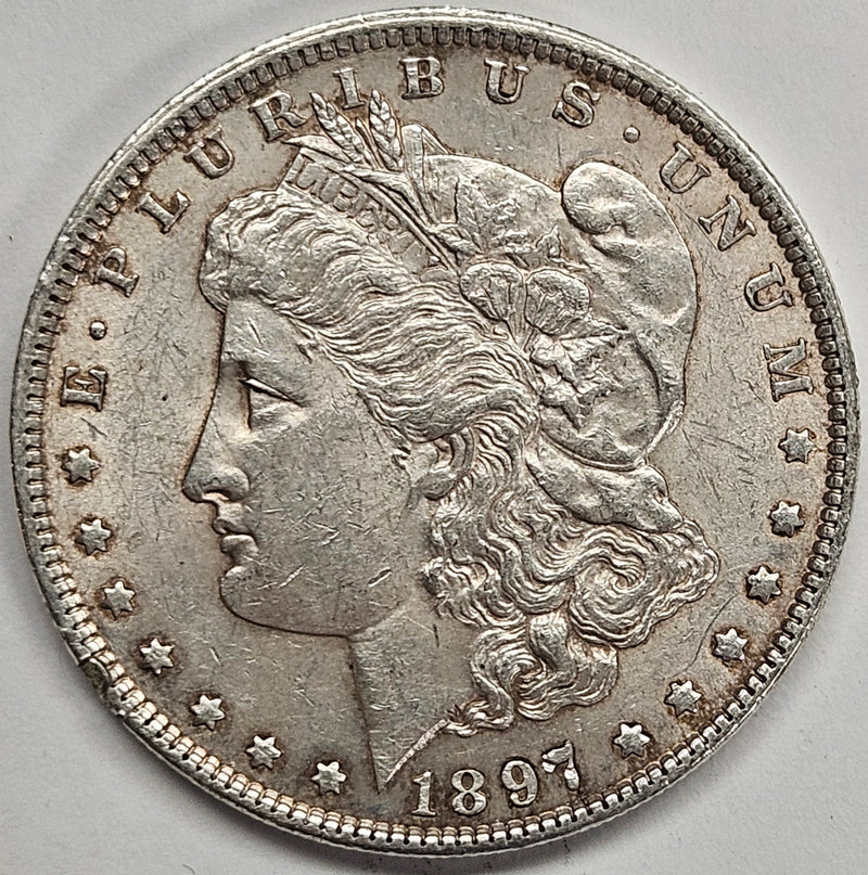 1897 Morgan Dollar . . . . AU rim hit