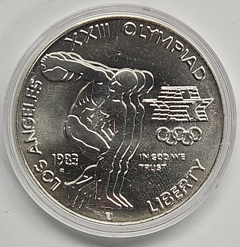 1983-D LA Olympic Discus Thrower Silver Dollar . . . . Gem BU in original U.S. Mint Capsule